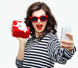 Girl Holding Gift Taking A Selfie Front Holiday Gift Ideas in Lancaster for the Whole Family
