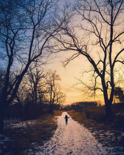 Girl Running Down Path In Winter Sunset It's interesting how people will build their own rules into their art.