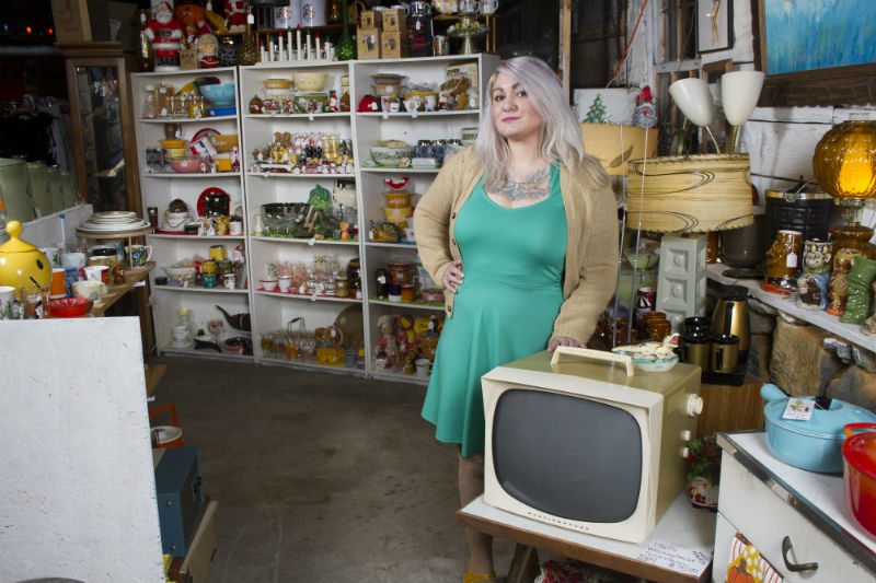 Rose Nutter Standing In Her Shop With Television